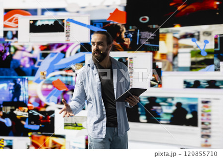 Young social influencer presenting a live discussion to a virtual audience, using visuals and user experience design to boost visibility and reach. Build brand voice in the digital online world. 129855710