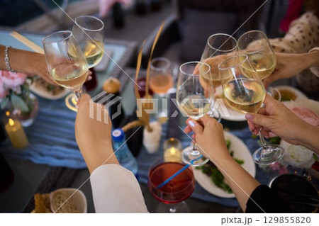 A Celebration Toast featuring beautifully crafted Champagne Glasses filled with bubbly drink 129855820