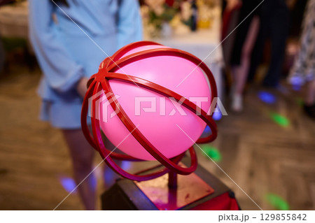 A colorful Balloon Hat adds fun and creativity to a lively community event celebration 129855842