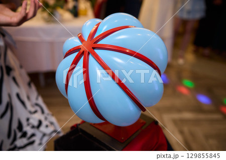 A colorful Balloon Hat adds fun and creativity to a lively community event celebration A colorful Balloon Hat adds fun and creativity to a lively community event celebration 129855845