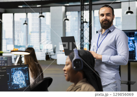 Portrait of team leader supervising programmers at work training deep learning models for anomaly detection. Supervisor overseeing IT workers using artificial intelligence in office to do tasks Portrait of team leader supervising programmers at work training deep learning models for anomaly detection. Supervisor overseeing IT workers using artificial intelligence in office to do tasks 129856069