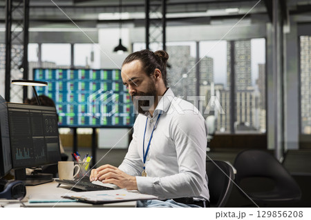Office employee engages in brainstorming sessions and data analysis, leveraging insights and technology to align the strategy with objectives and support for efficient project execution. 129856208