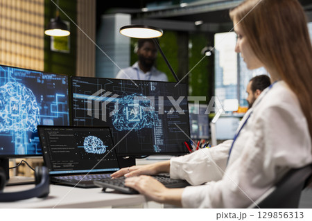 Female engineer developing applications using AI LLM chatbot on multiple devices. Worker doing internship in tech startup relying on artificial intelligence assistant to debug applications Female engineer developing applications using AI LLM chatbot on multiple devices. Worker doing internship in tech startup relying on artificial intelligence assistant to debug applications 129856313