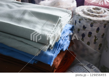 heap of colorful cloth on shelf for sale in store heap of colorful cloth on shelf for sale in store 129856455