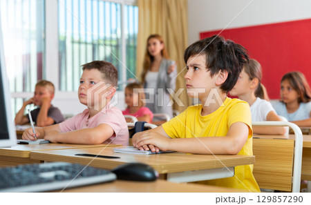 Schoolboy sitting in classroom during lesson in elementary school 129857290