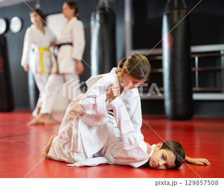 Teenage boy and girl practicing karate 129857508
