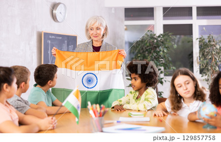 Friendly woman teacher tells pupils the history of India 129857758
