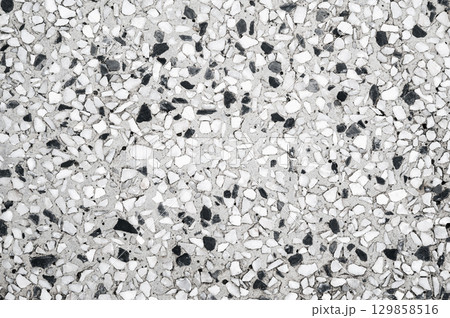 background with a rough sidewalk texture with natural white pebbles. Surface of decorative pavement background with a rough sidewalk texture with natural white pebbles. Surface of decorative pavement 129858516