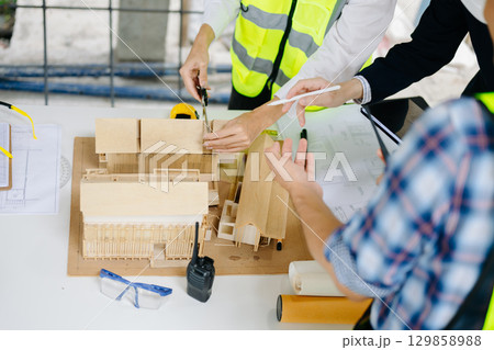 Engineer teams meeting working together wear worker helmets hardhat on construction site Engineer teams meeting working together wear worker helmets hardhat on construction site 129858988