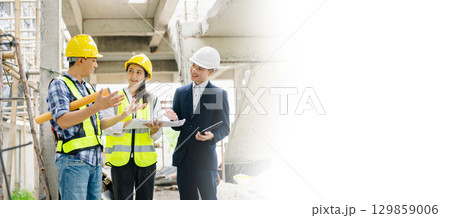 Contractor and architect looking at plan, tablet, laptop and talking about working on big project. Contractor and architect looking at plan, tablet, laptop and talking about working on big project. 129859006