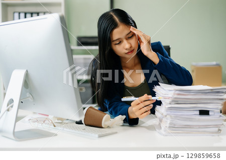Asian businesswoman is stressed, bored, and overthinking from working 129859658