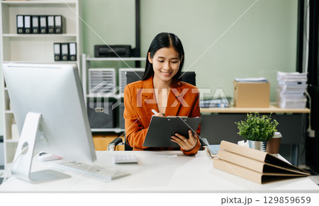 Asian woman sitting at a desk using a laptop computer Navigating Finance and Marketing Asian woman sitting at a desk using a laptop computer Navigating Finance and Marketing 129859659
