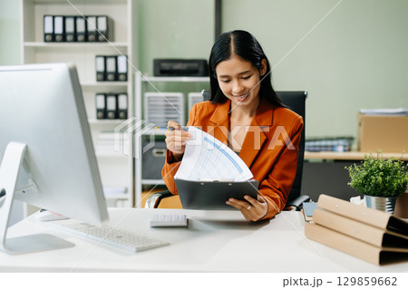 Asian woman sitting at a desk using a laptop computer Navigating Finance and Marketing Asian woman sitting at a desk using a laptop computer Navigating Finance and Marketing 129859662