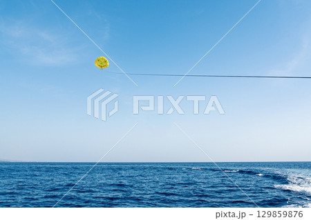 Parasailing Adventure A Thrilling Water Sport Experience on a Sunny Day at the Sea 129859876