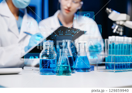 Scientist two woman with tablet and laptop, laboratory and ecofriendly science. Agriculture, research and scientists with online reading, test samples 129859940