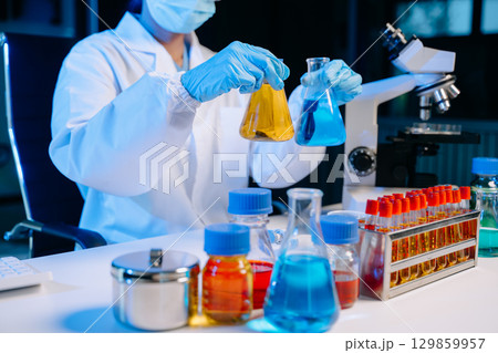 Female biotechnologist testing new chemical substances in a laboratory. 129859957