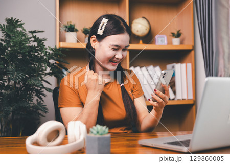 Homeschool Asian girl student learning virtual internet online class from school teacher by remote meeting. Female teaching math by headphone. education concept. student with computer study at school 129860005