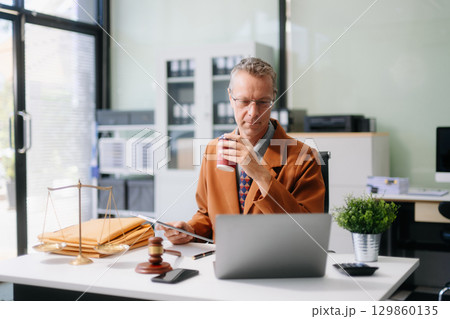 Professional male lawyers consulting on legal cases in a modern office. Perfect for law, business, justice, legal advice Professional male lawyers consulting on legal cases in a modern office. Perfect for law, business, justice, legal advice 129860135