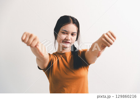 Asian girl expresses dislike, person express negative feeling, concept business complaint from customer ensuring employee satisfaction negative feedback to prevent mental strain customer dislike Asian girl expresses dislike, person express negative feeling, concept business complaint from customer ensuring employee satisfaction negative feedback to prevent mental strain customer dislike 129860216
