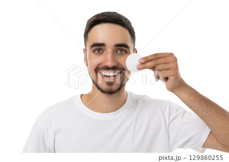 Man holds cotton pad to face while smiling, isolated, PNG Man holds cotton pad to face while smiling, isolated, PNG 129860255