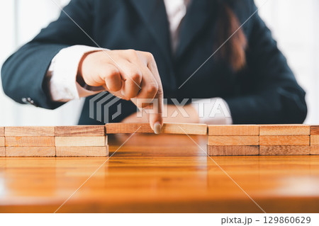 Business risk control concept, Businesswoman protect wooden block fall to planning and strategy in risk to business alternative and prevent. investment insurance business. Business risk control concept, Businesswoman protect wooden block fall to planning and strategy in risk to business alternative and prevent. investment insurance business. 129860629