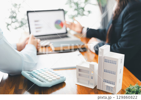 Home loan officer uses calculator with house plan loan real estate or property. important to loan calculator seek real estate, finance insurance advice ensure smart financial decisions for business. Home loan officer uses calculator with house plan loan real estate or property. important to loan calculator seek real estate, finance insurance advice ensure smart financial decisions for business. 129860822