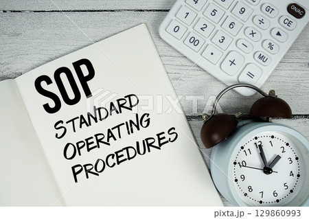 SOP Standard Operating Procedures text on paper notebook page with alarm clock and calculator on wooden background SOP Standard Operating Procedures text on paper notebook page with alarm clock and calculator on wooden background 129860993