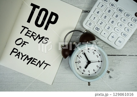 TOP Terms Of Payment text on paper notebook page with alarm clock and calculator on wooden background 129861016