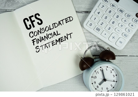 CFS Consolidated Financial Statement text on paper notebook page with alarm clock and calculator on wooden background CFS Consolidated Financial Statement text on paper notebook page with alarm clock and calculator on wooden background 129861021