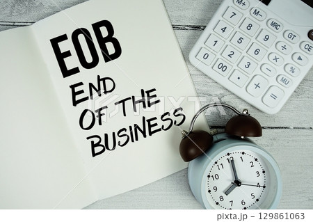 EOB End Of the Business text on paper notebook page with alarm clock and calculator on wooden background EOB End Of the Business text on paper notebook page with alarm clock and calculator on wooden background 129861063