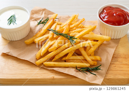 French fries with sour cream and ketchup French fries with sour cream and ketchup 129861245