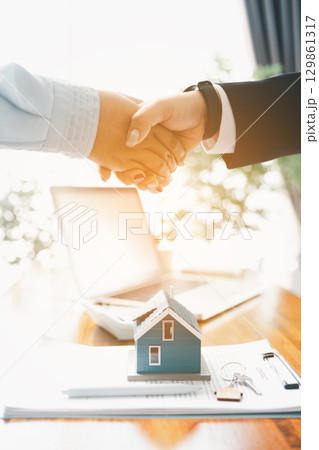 Business of finance, financial and banking investments in real estate buying, selling, purchasing commercial apartment. team meeting in office, growth concept, against background of banking ownership Business of finance, financial and banking investments in real estate buying, selling, purchasing commercial apartment. team meeting in office, growth concept, against background of banking ownership 129861317