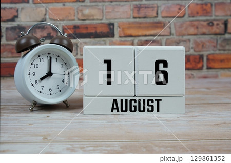 Wooden Calendar Showing the Date of August 16th. Day 16 of August month 129861352