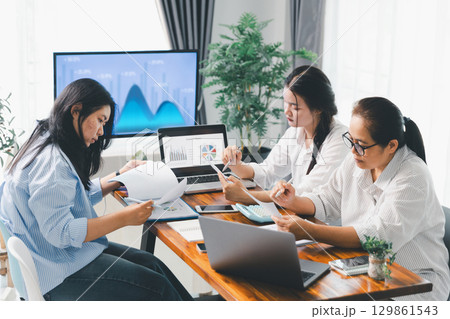 Financial business team in office, financial expert analyze business report graph and finance chart at corporate office. Concept of finance economy, banking business and stock market research. Financial business team in office, financial expert analyze business report graph and finance chart at corporate office. Concept of finance economy, banking business and stock market research. 129861543