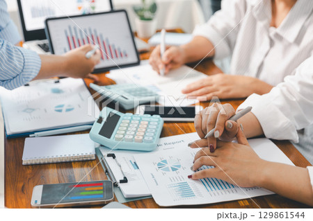 Financial business team in office, financial expert analyze business report graph and finance chart at corporate office. Concept of finance economy, banking business and stock market research. Financial business team in office, financial expert analyze business report graph and finance chart at corporate office. Concept of finance economy, banking business and stock market research. 129861544