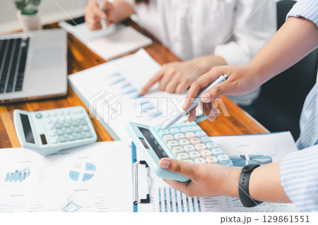Financial business team in office, financial expert analyze business report graph and finance chart at corporate office. Concept of finance economy, banking business and stock market research. Financial business team in office, financial expert analyze business report graph and finance chart at corporate office. Concept of finance economy, banking business and stock market research. 129861551