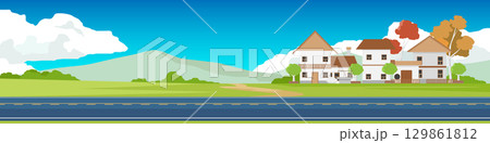 Horizontal and Landscape of Asphalt road. Rural village in a retro European style. Surrounded by vast grasslands and connected by dirt roads. With mountain under white clouds and blue sky. Horizontal and Landscape of Asphalt road. Rural village in a retro European style. Surrounded by vast grasslands and connected by dirt roads. With mountain under white clouds and blue sky. 129861812