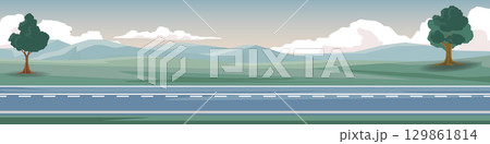 Horizontal or landscape asphalt road. On the wide grassland with grass and trees side of the road. Soft colors of the mountains and a calm evening sky. 129861814