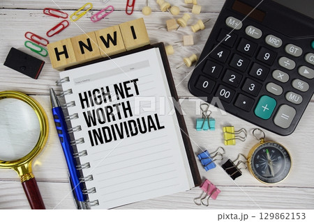 HNWI High Net-Worth Individual acronym on notepad, business and financial concept background 129862153