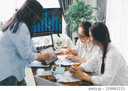 Financial business team in office, financial expert analyze business report graph and finance chart at corporate office. Concept of finance economy, banking business and stock market research. 129862213