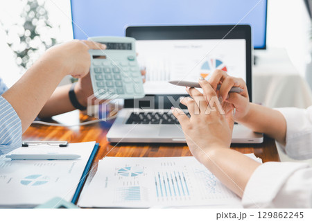 Financial business team in office, financial expert analyze business report graph and finance chart at corporate office. Concept of finance economy, banking business and stock market research. 129862245