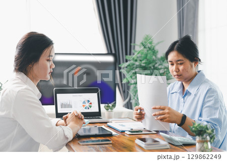 People meeting using laptop computer, calculator, stock market chart paper for analysis plans to improve quality. Team working on project. Analysis business brainstorming corporate smart Concept. People meeting using laptop computer, calculator, stock market chart paper for analysis plans to improve quality. Team working on project. Analysis business brainstorming corporate smart Concept. 129862249