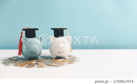 Concept of saving money for education, student loan, scholarship in future. Piggy bank with graduation hat, stack of coins. Earth globe with graduation hat, dollar banknotes on table. Tuition fees Concept of saving money for education, student loan, scholarship in future. Piggy bank with graduation hat, stack of coins. Earth globe with graduation hat, dollar banknotes on table. Tuition fees 129862454
