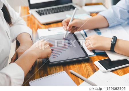 Teamwork meeting, business people in office workplace. Collaboration, technology and worker, employees with touchscreen planning sales, research or financial strategy, staff for conversation, graph 129862505