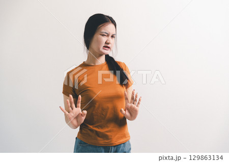 Asian girl expresses dislike, person express negative feeling, concept business complaint from customer ensuring employee satisfaction negative feedback to prevent mental strain customer dislike 129863134