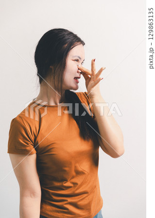 Asian girl expresses dislike, person express negative feeling, concept business complaint from customer ensuring employee satisfaction negative feedback to prevent mental strain customer dislike 129863135