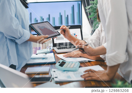 Teamwork with business people analysis cost graph on desk at meeting room. partnership analysis graph company financial budget report, cost work progress planning, business team analysis graph data Teamwork with business people analysis cost graph on desk at meeting room. partnership analysis graph company financial budget report, cost work progress planning, business team analysis graph data 129863208