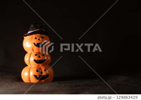 Jack O Lantern Pumpkins on Black Background 129863429