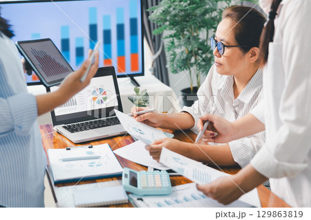 Teamwork with business people analysis cost graph on desk at meeting room. partnership analysis graph company financial budget report, cost work progress planning, business team analysis graph data Teamwork with business people analysis cost graph on desk at meeting room. partnership analysis graph company financial budget report, cost work progress planning, business team analysis graph data 129863819