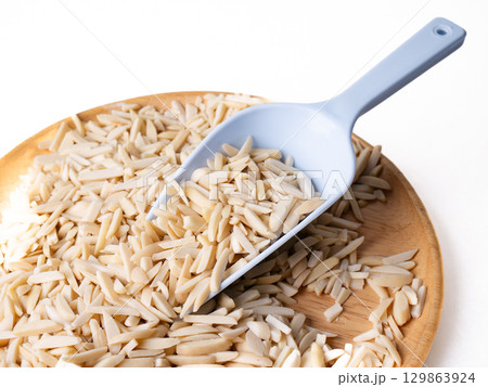 White Almond Stick set on wooden board with versatile scoop and white background. 129863924